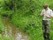 Ichthyology member collects water sample